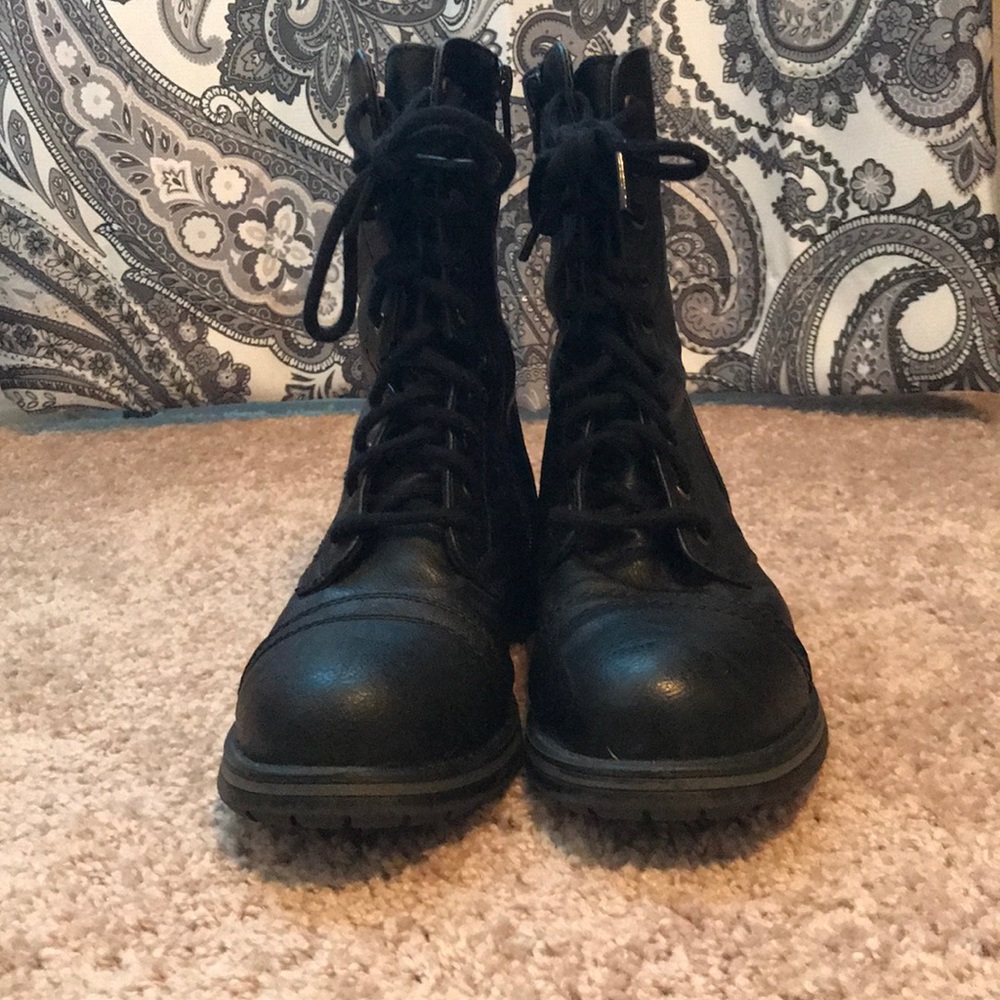 Lace up black boots, with side zippers.